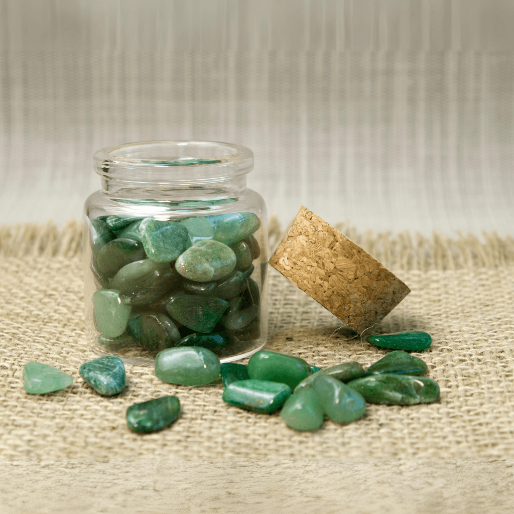 Green aventurine tumbled stone in a jar