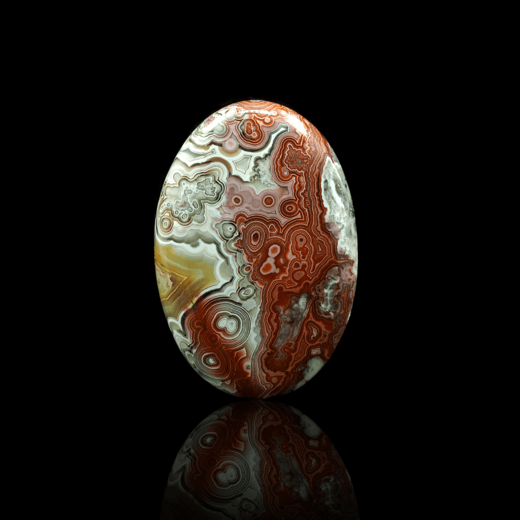 oval shaped crazy lace agate front angle with black background