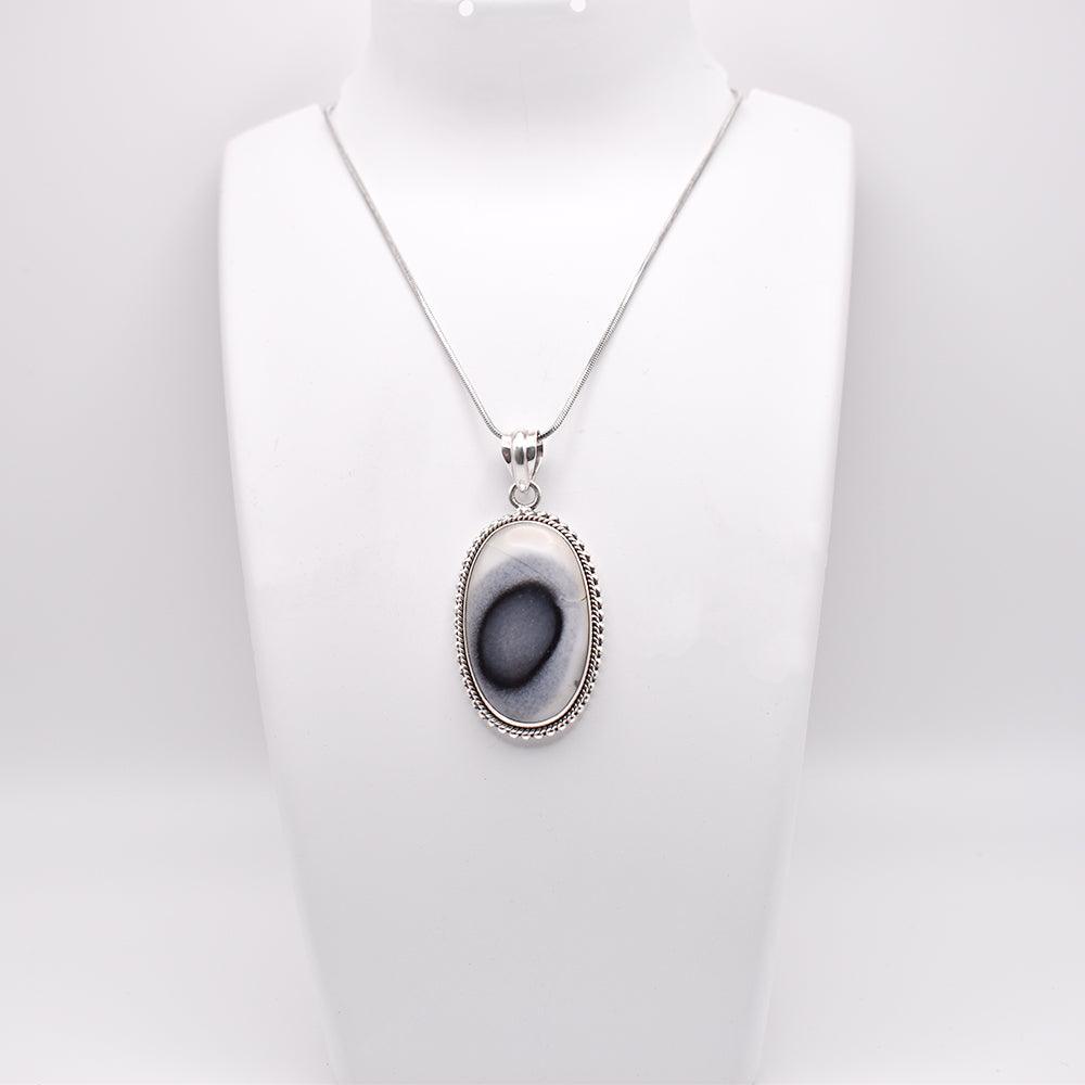 Dendritic Agate Pendant with chain on jewelry display 