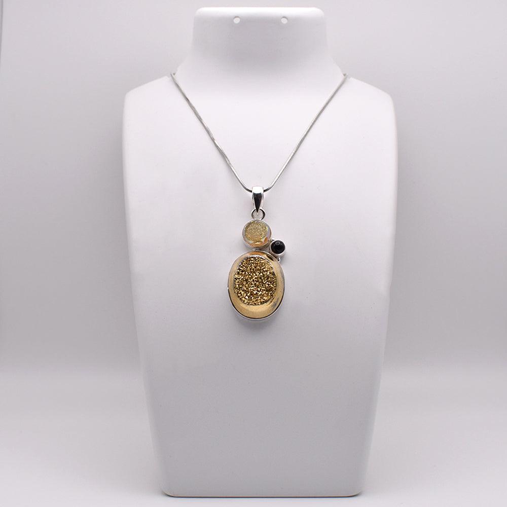 Oval shaped Druzy Pendant With Black Onyx on jewelry display