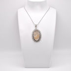 Golden Rutile Pendant on jewelry display 