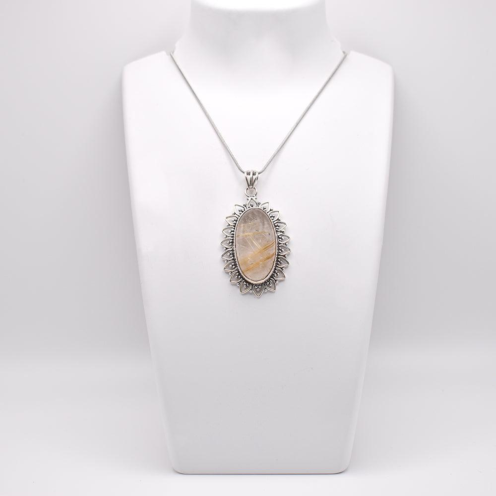 Golden Rutile Pendant on jewelry display 
