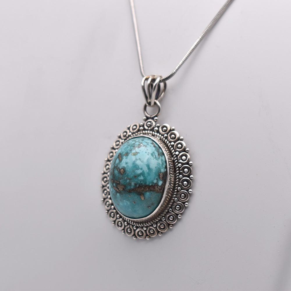 925 Sterling Silver blue colored oval shaped Iranian Turquoise Pendant on white background 