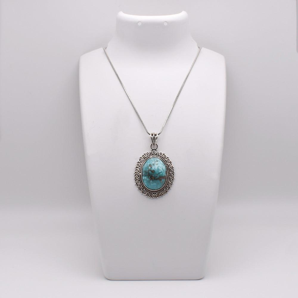 925 Sterling Silver blue colored oval shaped Iranian Turquoise Pendant on jewelry display 