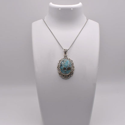  blue colored oval shaped natutal Iranian Turquoise Pendant on jewelry display 