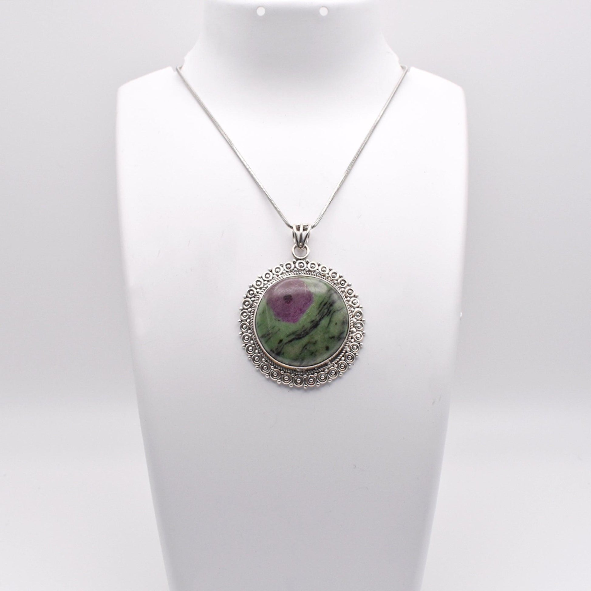 925 Sterling Silver circle shaped Ruby Zoisite Pendant on jewelry display 