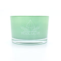 Green tea-scented crystal candle in frosted green jar with raw crystals