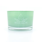 Green tea-scented crystal candle in frosted green jar with raw crystals