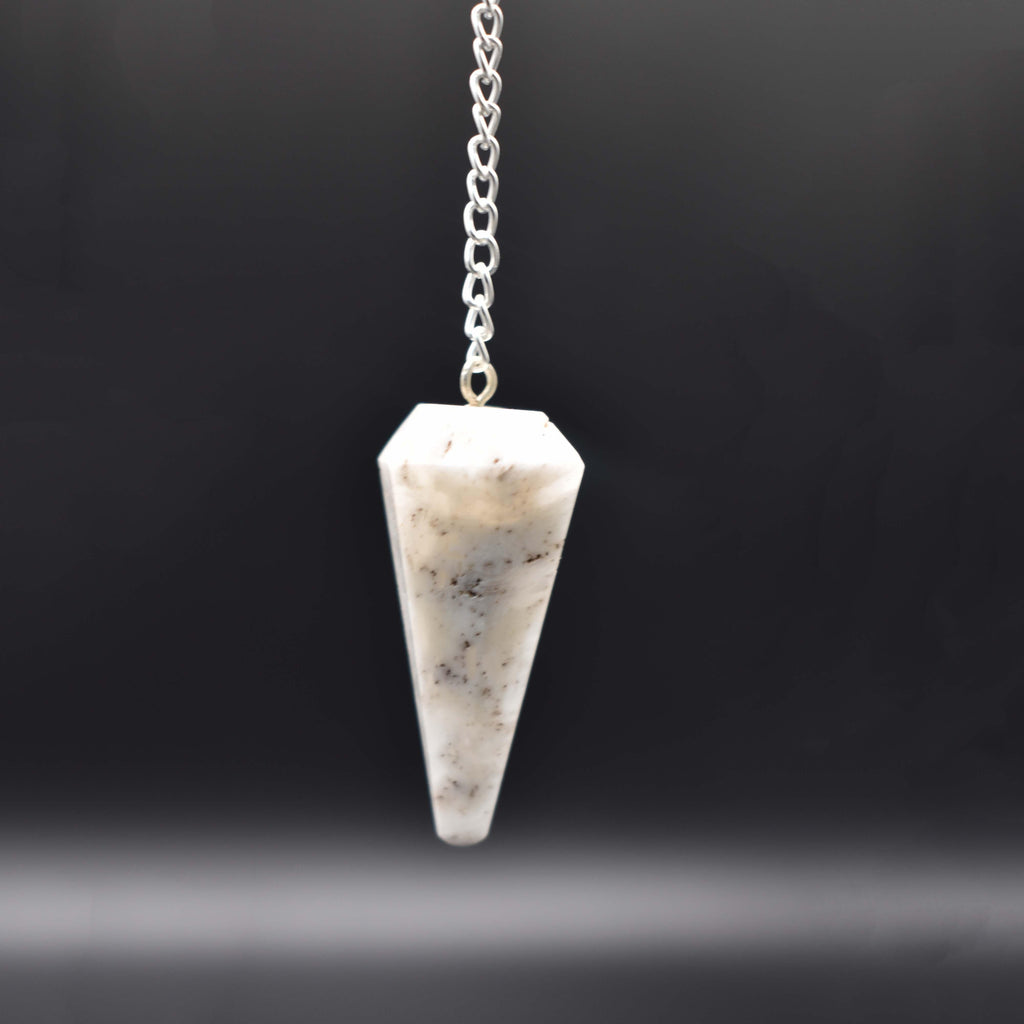 Hanging scolecite pendulum with black background