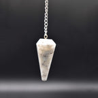 Hanging scolecite pendulum with black background