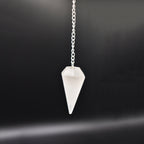Hanging Selenite pendulum front angle with black back gound 