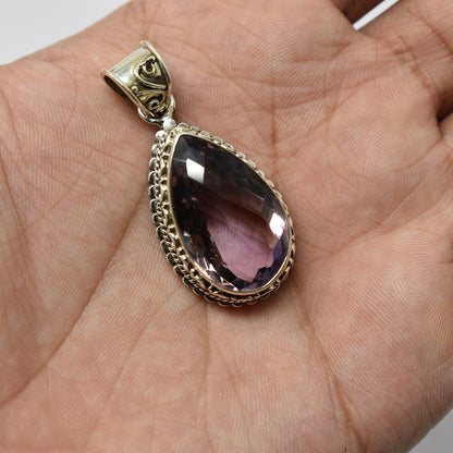 925 Sterling Silver Ametrine purple color pendant in hand front angle on skin color background
