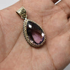 925 Sterling Silver Ametrine purple color pendant in hand front angle on skin color background