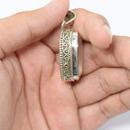 925 Sterling Silver Rose Quartz pink colored Pendant side angle in hand on skin colored background