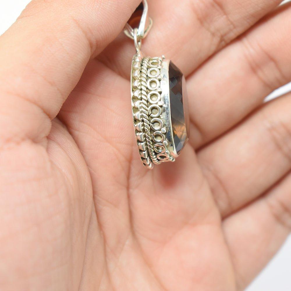 925 sterling Silver smokey topaz Pendant in hand side angle